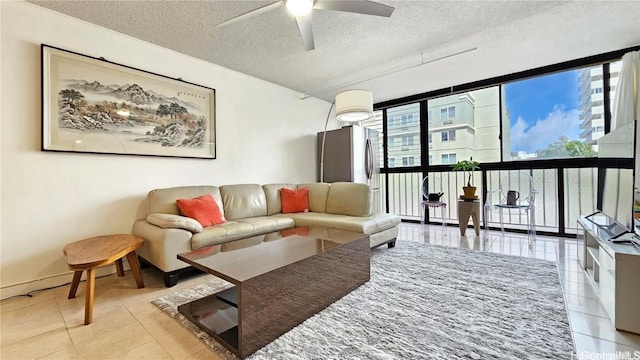 tiled living room with a textured ceiling, plenty of natural light, and ceiling fan