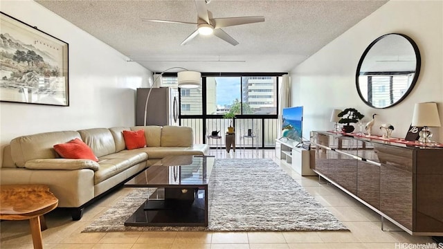 tiled living room featuring ceiling fan and a textured ceiling