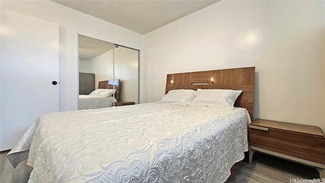 bedroom featuring dark hardwood / wood-style floors and a closet