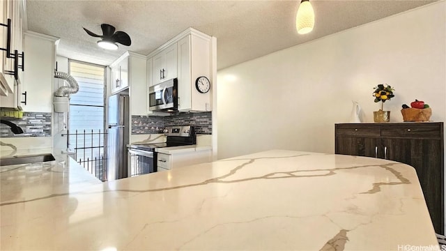 bedroom featuring a textured ceiling, stainless steel refrigerator, and sink