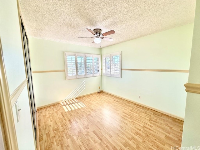 unfurnished room with wood-type flooring, a textured ceiling, and ceiling fan