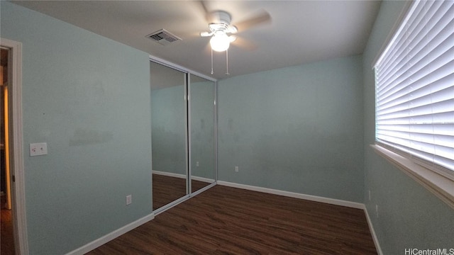 unfurnished bedroom featuring ceiling fan, a closet, and dark hardwood / wood-style floors