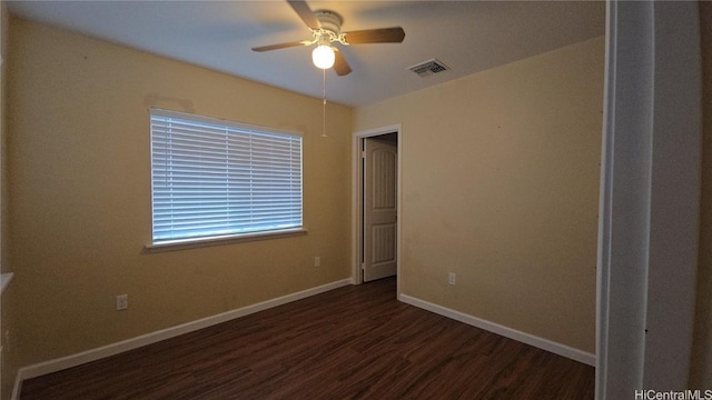 unfurnished room featuring ceiling fan and dark wood-type flooring