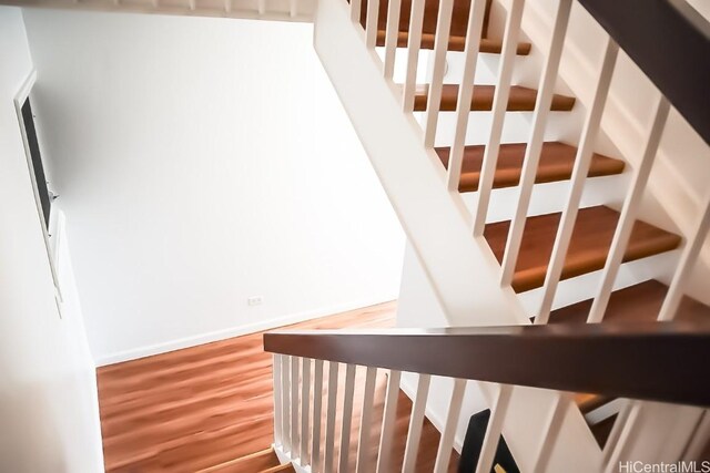 stairs with hardwood / wood-style flooring