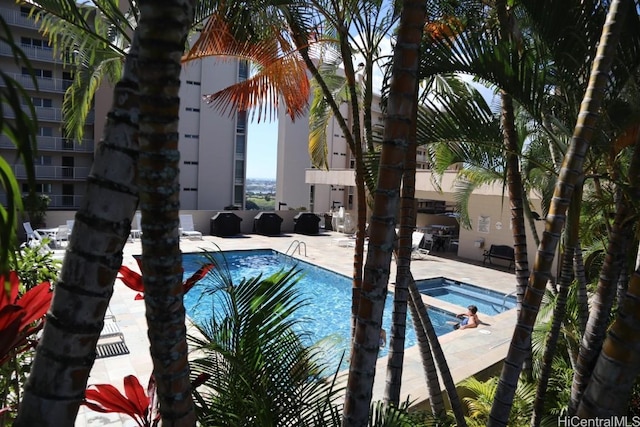 view of pool featuring a patio area and a community hot tub