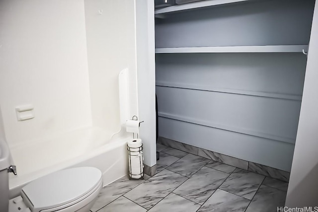 bathroom with shower / bath combination and toilet