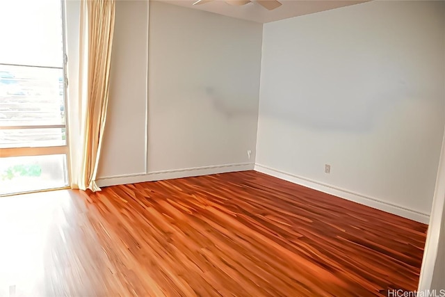 empty room with hardwood / wood-style floors and ceiling fan