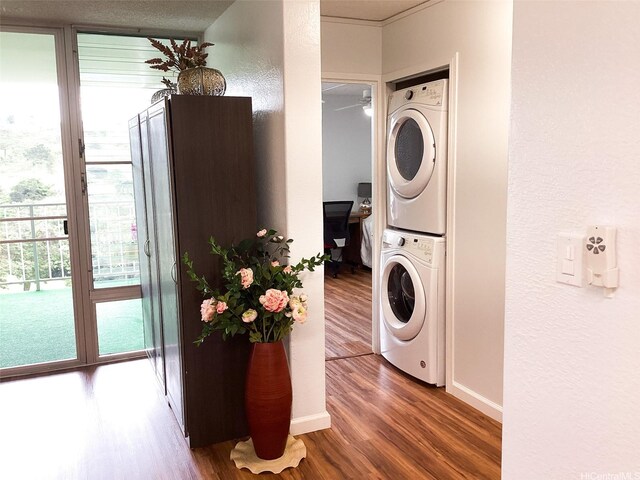 98-707 Iho Pl Unit 2102, Aiea, HI 96701 - laundry room featuring stacked washer / drying machine, wood finished floors, a ceiling fan, and a textured wall