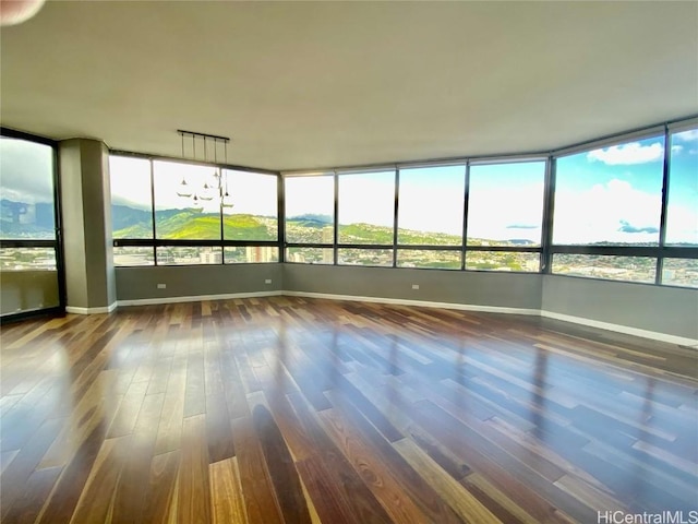 unfurnished sunroom with a wealth of natural light and a mountain view