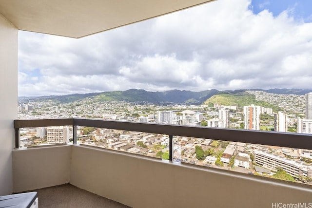 balcony featuring a city view and a mountain view