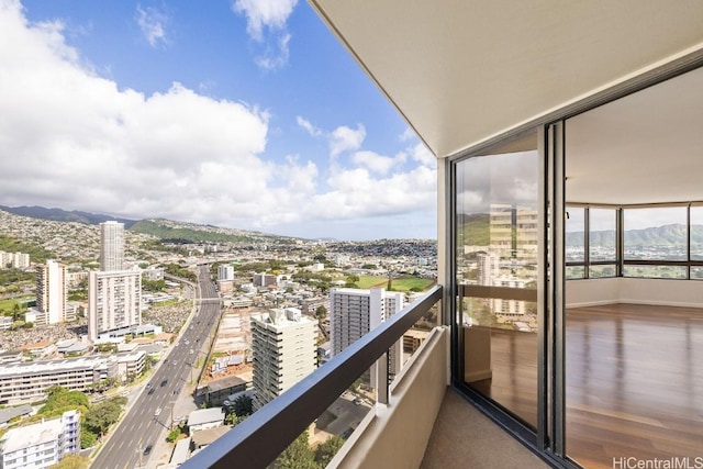 balcony featuring a city view and a mountain view