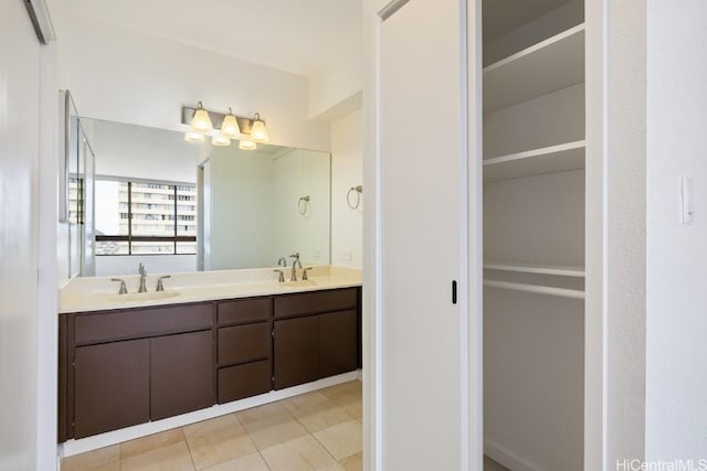 bathroom featuring double vanity, tile patterned flooring, and a sink