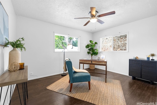 office featuring a textured ceiling, ceiling fan, and dark wood-type flooring