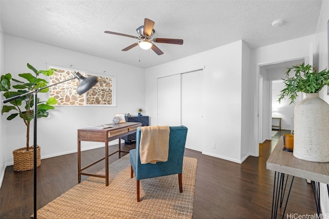 office featuring ceiling fan, dark hardwood / wood-style flooring, and a textured ceiling