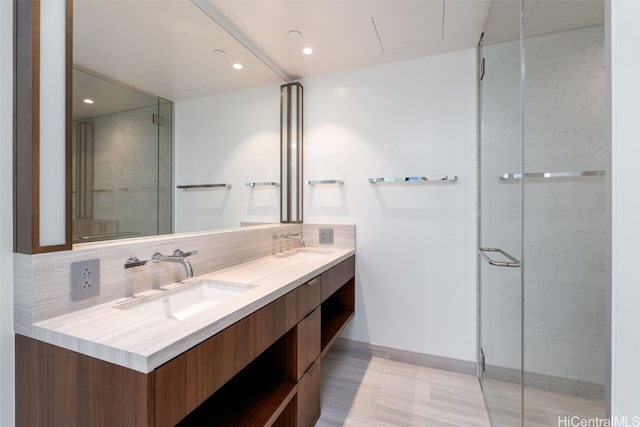 bathroom with hardwood / wood-style floors, vanity, and tasteful backsplash