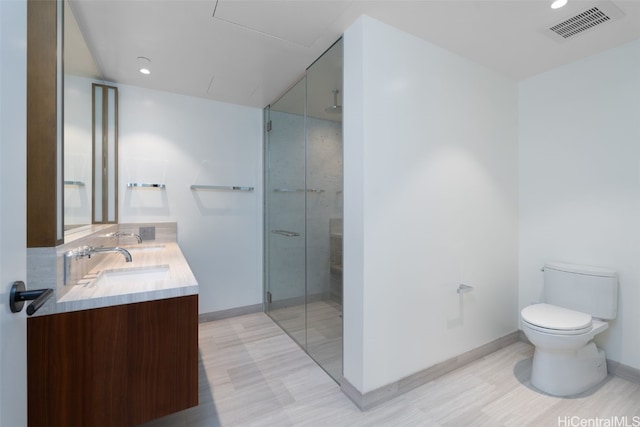 bathroom with vanity, toilet, and walk in shower