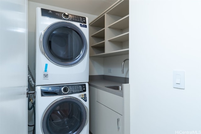 washroom with sink and stacked washer and dryer