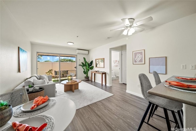 living room featuring an AC wall unit, ceiling fan, and hardwood / wood-style floors