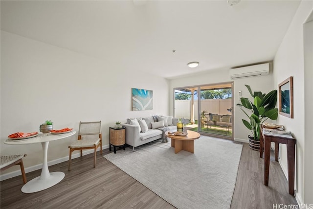 living room featuring wood-type flooring and an AC wall unit