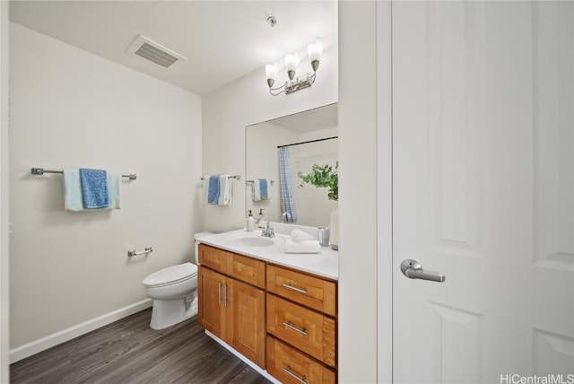 bathroom featuring a shower with curtain, vanity, wood-type flooring, and toilet