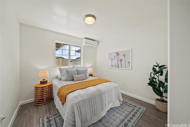 bedroom with a wall mounted air conditioner and dark wood-type flooring