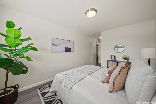 bedroom with dark hardwood / wood-style floors