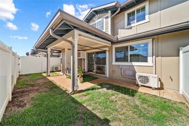 back of house with a lawn, ac unit, and a patio area