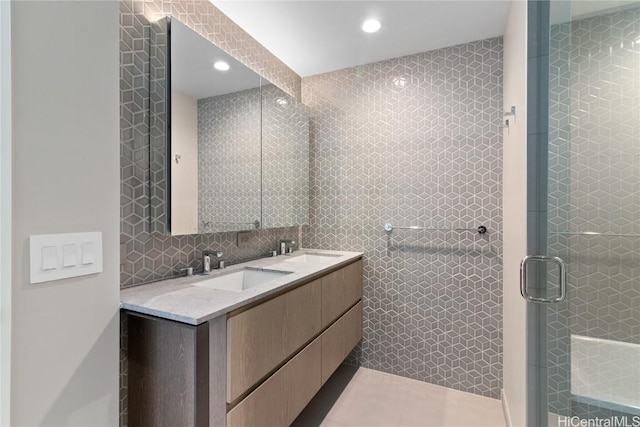 bathroom featuring tasteful backsplash, vanity, and tile walls