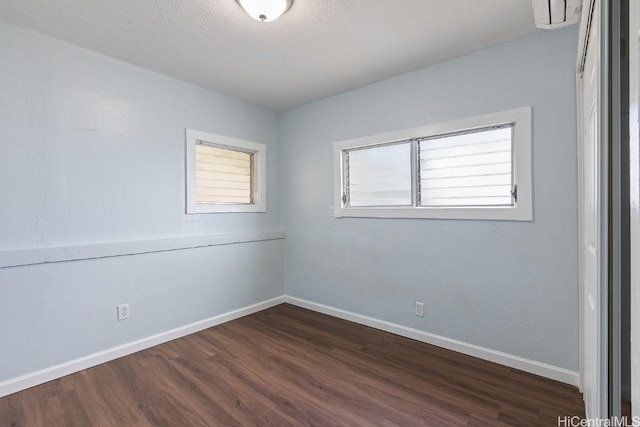 empty room with dark wood-type flooring