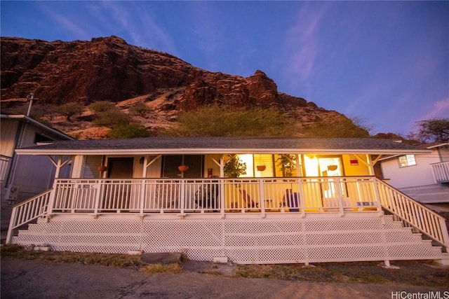 view of front of property with a mountain view and covered porch