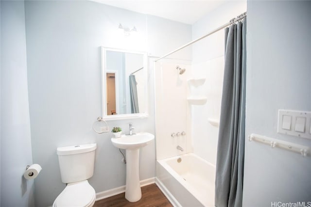 bathroom featuring hardwood / wood-style floors, shower / tub combo, and toilet