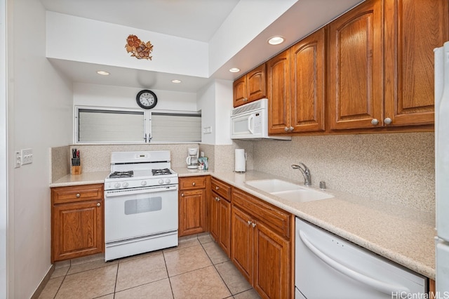 kitchen with backsplash, sink, and white appliances