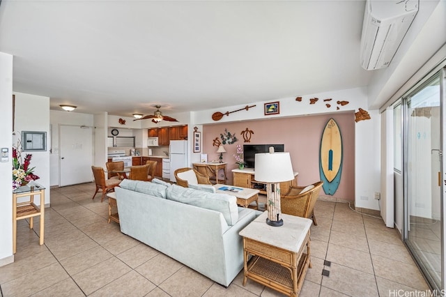 tiled living room featuring a wall unit AC and ceiling fan