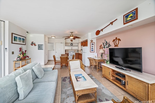 living room featuring ceiling fan, light tile patterned flooring, and electric panel