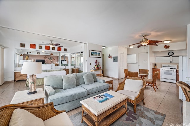 tiled living room featuring ceiling fan and a healthy amount of sunlight