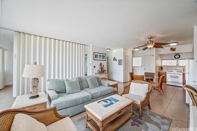 living room featuring light tile patterned floors and ceiling fan