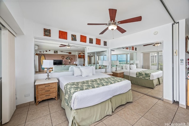 tiled bedroom with ceiling fan and white fridge