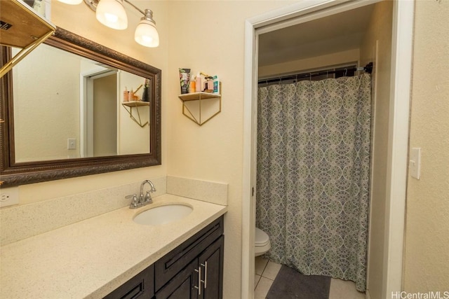 bathroom featuring tile patterned floors, vanity, and toilet