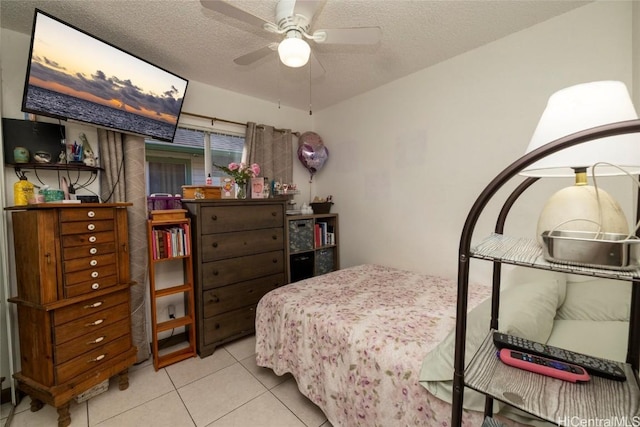 tiled bedroom featuring ceiling fan and a textured ceiling