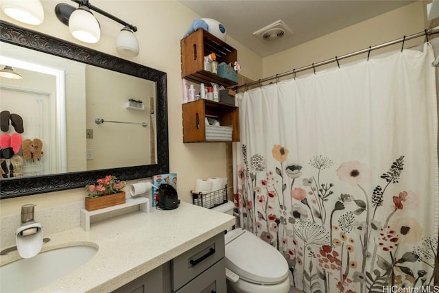 bathroom with vanity, toilet, and curtained shower