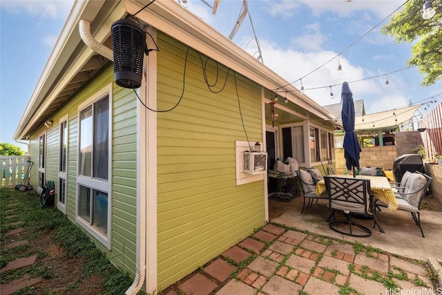 view of property exterior featuring a patio and an outdoor hangout area