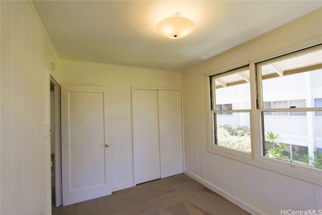 unfurnished bedroom with a closet and carpet