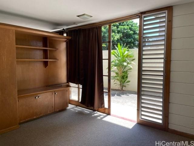 entryway featuring carpet flooring and wood walls