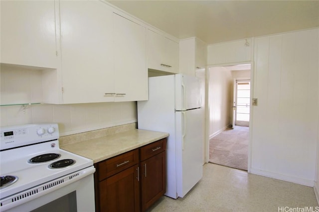 kitchen featuring white appliances, decorative backsplash, and white cabinets