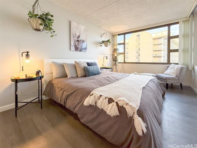 bedroom featuring hardwood / wood-style floors and a textured ceiling