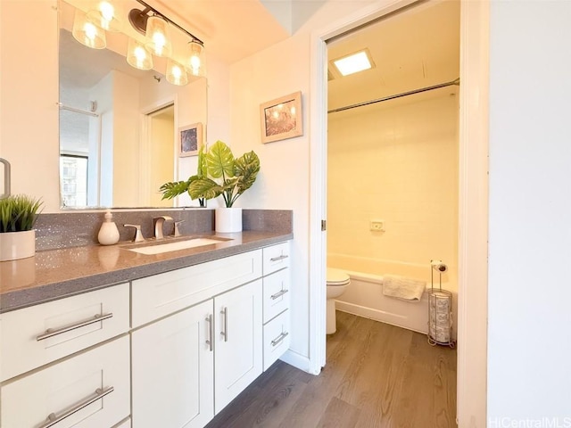 full bathroom featuring vanity, shower / bathtub combination, toilet, and wood-type flooring