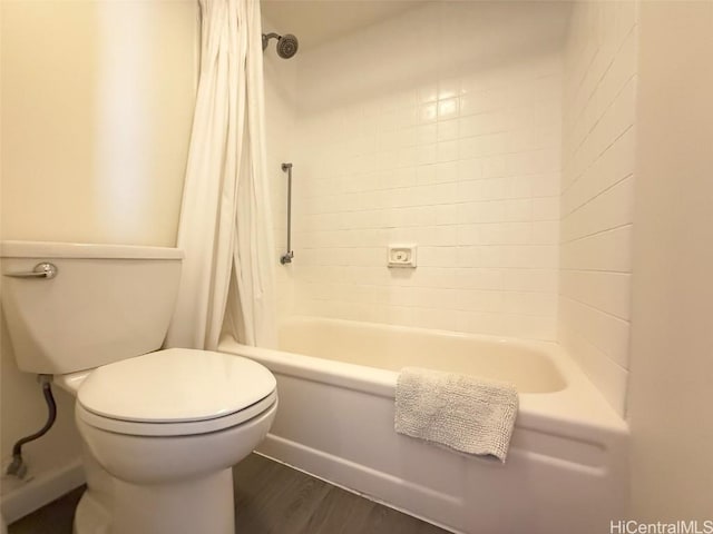 bathroom with toilet, hardwood / wood-style flooring, and shower / tub combo with curtain