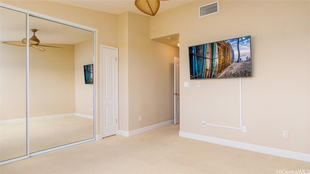 unfurnished bedroom featuring carpet and a closet