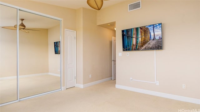 unfurnished bedroom featuring carpet floors, a closet, visible vents, and baseboards