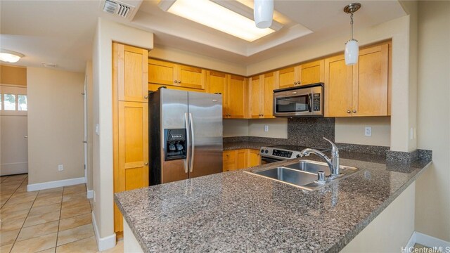 kitchen featuring light brown cabinets, sink, light tile patterned floors, appliances with stainless steel finishes, and kitchen peninsula